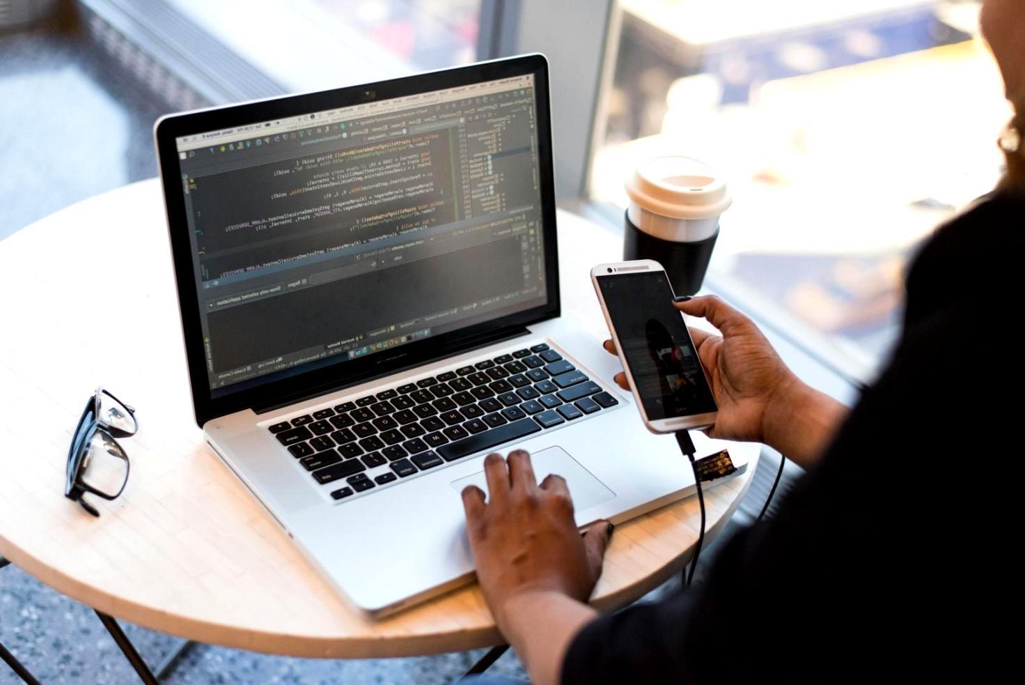 Mobile game development workspace showing multiple devices testing games and development environment